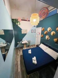 a room with a blue bed with towels on it at Kofler GuestHouse in Barletta