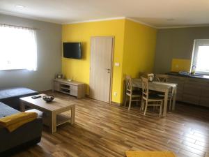 a living room with a table and a dining room at Apartmán Lomňanka in Dolní Lomná