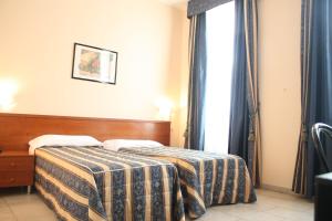 Posteľ alebo postele v izbe v ubytovaní Hotel Alessander