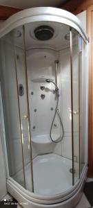 a shower with a glass door in a bathroom at Apartment Višnja in Vodice