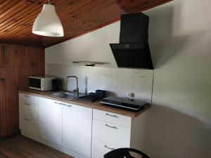 a small kitchen with a sink and a microwave at SOFT ROOMS in Vila Real