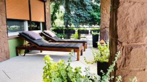 two benches with pillows sitting on a patio at Pod Świerkami in Boszkowo