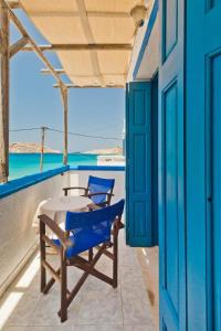 a patio with a table and chairs on a balcony at Aegean View Studios in Lefkos Karpathou