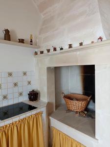 kuchnia z kominkiem i koszem na ladzie w obiekcie Casa vacanze Chiarodiluna w mieście Giurdignano