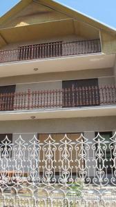 a balcony on a building with white and brown tiles at Lelita in Bela Crkva