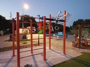 a park with a playground with a swing at Camping Volme in Banjole
