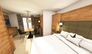 a bedroom with a large white bed and a desk at Haus Ornach in Oberjoch