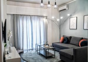 a living room with a couch and a table at Lux apartment near Acropolis! in the Heart of Athens in Athens