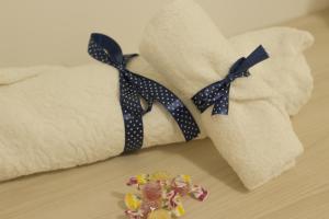two towels with polka dot ties sitting on a table at Respice Stellam casa vacanza in Castellaneta