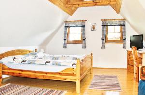 a bedroom with a wooden bed and a tv at Ferienhaus Possath in Leutschach