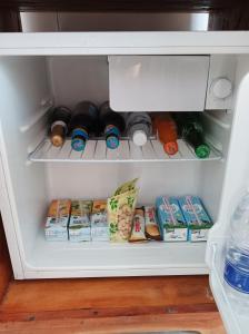 a refrigerator filled with lots of food and drinks at Zanzicrown in Nungwi