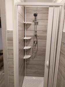 a shower in a bathroom with a showeroser at Casa Nicolò Vista Lago in Stresa