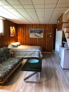 a living room with two beds and a couch at Fanny et Maxime in Gatineau