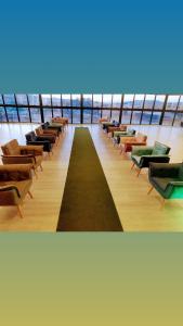 a row of chairs in a room with the ocean at Village Plaza Hotel in Barbacena