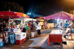 a crowd of people at an outdoor market at night at Appartement 500 mètres de la plage à GOSIER in Le Gosier