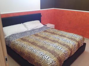 ナポリにあるRelax in Suiteのヒョウ柄の掛け布団付きのベッド1台