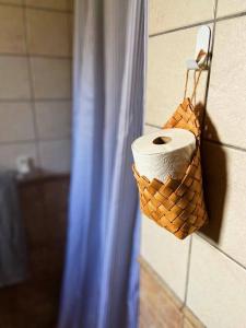 a roll of toilet paper in a basket on a wall at Apartamento rural el Vidre VT-42035-CS in Vistabella del Maestrazgo +39 photos