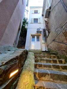 an alley with stairs leading to a white building at Freedom studio in Piran