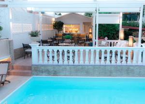 a house with a swimming pool and a porch with a patio at Armata Boutique Hotel in Spetses