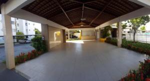 an empty lobby of a building with a large porch at Aruana beach flat - seu apê na praia de Aruana, Aracaju! in Aracaju
