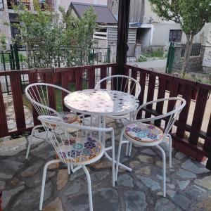 a table and three chairs sitting on a patio at BAH house in Kolašin
