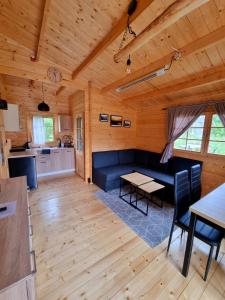 a living room with a couch and a table at Zacisze Śniardwy in Nowe Guty