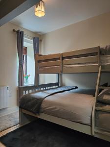 a bedroom with two bunk beds and a window at The Koze in Leitrim