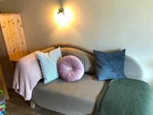 a couch with pillows on it in a room at Ferienhaus Mautzfried in Reisach