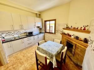 a kitchen with a table and a fireplace at Lovely spacious apartment in the center - Vilaflor in Vilaflor