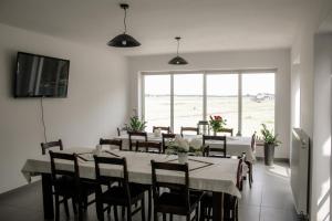 a dining room with a table and chairs with a view of the beach at Bielik in Dęblin