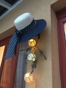 a hat hanging on the side of a building at Viharsarki Apartman in Gyula