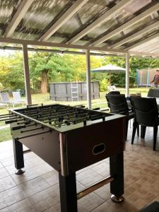 a large foosball table sitting on a patio at Viharsarki Apartman in Gyula