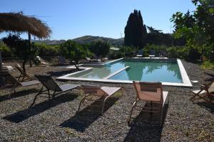 a swimming pool with two chairs and a swimming pool at Villa La Cucullera in Catanzaro