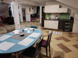 a blue table with chairs and a kitchen in a room at Montenegro Colors in Kamenari