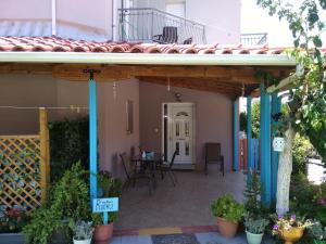a porch of a house with a table and chairs at Valta's Room 2 in Paleros