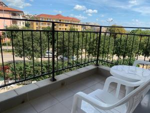 a balcony with a table and chairs and a view of a building at Studio Fatinia in Byala