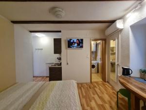 a living room with a television on the wall at Rooms & Studio Apartments Šibenik in Šibenik