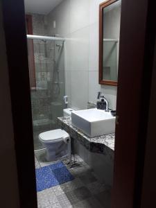 a bathroom with a sink and a toilet at Solar dos Reis Apartamento Topázio in Ouro Preto