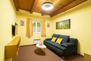 a living room with a couch and a table at APARTMÁNY V PARKU in Lednice