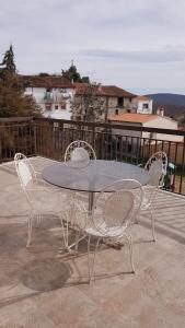 a table and four chairs on a patio at Apartamento Buenavista in Villamiel