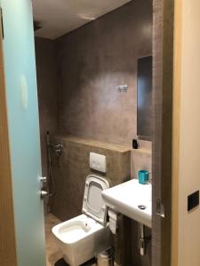 a bathroom with a toilet and a sink at Rittson - Boutique Hotel in Vlorë