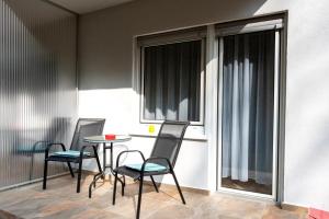 a room with a table and chairs and a balcony at Hotel Blüchertal Bacharach in Bacharach