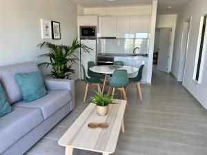 a living room with a couch and a table at Apartamentos Fayna in Puerto del Carmen