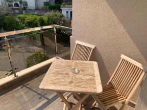a wooden table and two chairs on a balcony at Apartment Dunja in Boreti
