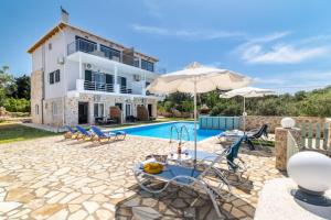 a villa with a swimming pool and a house at Sea view apartments in Tsoukalades