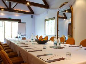 a large long table in a room with chairs at Cotswold House Hotel and Spa - "A Bespoke Hotel" in Chipping Campden