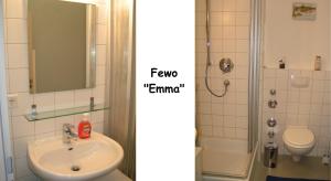 a bathroom with a sink and a toilet and a mirror at Ferienwohnungen Langenstraße - Altstadt in Stralsund +5 photos
