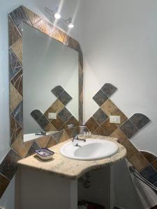 a bathroom with a sink and a mirror at Favignana Holidays 4 in Favignana