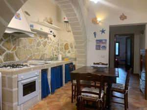 a kitchen with a table and a dining room at Favignana Holidays 4 in Favignana