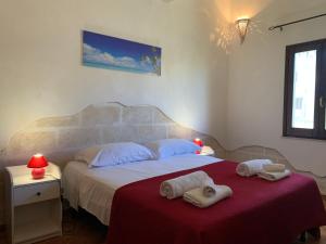 a bedroom with a bed with towels on it at Favignana Holidays 4 in Favignana